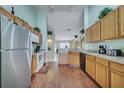 Bright kitchen featuring stainless steel appliances, wood cabinets and flooring at 16608 Rising Star Dr, Clermont, FL 34714