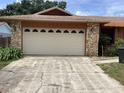 A closer look at the two-car garage, with decorative windows and stone pillars at 1414 Serissa Ct, Orlando, FL 32818