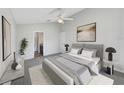 Well-lit bedroom featuring a striped bed frame and ceiling fan, creating a cozy and inviting atmosphere at 1078 Osprey Cove Cir, Groveland, FL 34736
