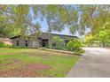 Charming home with stone accents, complemented by lush landscaping and a welcoming walkway at 1521 Oxford Rd, Maitland, FL 32751