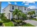 Well-manicured lawn and lush landscaping surrounds this two-story home with paved driveway and a two-car garage at 1697 Kona Ln, Davenport, FL 33897