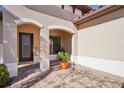 Front entry with arched entryway, and a potted plant at 310 Villa Sorrento Cir, Haines City, FL 33844