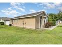 Rear exterior view of a well-kept home with a lush green lawn and serene backyard at 409 Horizon Dr, Winter Springs, FL 32708