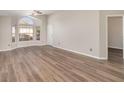 Spacious living room featuring wood-look flooring, large windows and neutral paint throughout at 409 Horizon Dr, Winter Springs, FL 32708