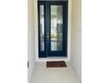 Modern entryway with a dark blue front door and a welcome mat at 737 Trillium Ct, Debary, FL 32713