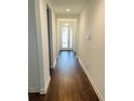 Long hallway with wood-look floors leading to other rooms at 737 Trillium Ct, Debary, FL 32713
