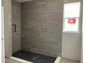 Modern bathroom with gray tile shower and hexagon floor tile at 16875 Muskgrass Dr, Winter Garden, FL 34787