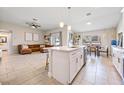 Bright living room area with a kitchen island, comfortable seating and natural light at 1302 Belmar Ter, Deltona, FL 32725