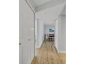 Bright hallway with light wood floors and white doors at 530 E Central Blvd # 201, Orlando, FL 32801