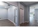 Bright hallway featuring wood-look tile flooring leading to an office space at 992 Jetway St, Orange City, FL 32763