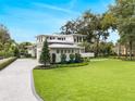 Modern home with attached garage and manicured lawn at 210 Chelton Cir, Winter Park, FL 32789