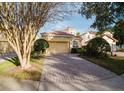 Front view of house showcasing garage and paved driveway at 8162 Via Bella Notte, Orlando, FL 32836