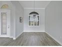 Elegant dining room featuring tile floors, decorative chandelier, a decorative window and a patterned front door at 5509 Meadow Hill Loop, Lady Lake, FL 32159