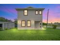 Inviting two-story home featuring a lovely front lawn, with a beautiful twilight sky at 821 E Story Rd, Winter Garden, FL 34787