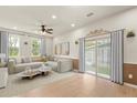 Bright living room with modern furnishings, recessed lighting, and sliding glass doors to the backyard at 821 E Story Rd, Winter Garden, FL 34787