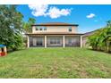Expansive backyard featuring a screened porch and lush landscaping perfect for outdoor entertaining and relaxation at 5232 Villa Rosa Ave, St Cloud, FL 34771