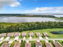 Stunning aerial view of a lakeside community with well-manicured lawns and picturesque waterfront scenery at 8060 Cherrystone St, Leesburg, FL 34748