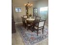 Dining room boasts a chandelier, and large window allowing for natural light at 2719 Lakemoor Dr, Orlando, FL 32828