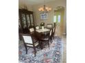 Formal dining room with chandelier, area rug, and hutch, ready for entertaining at 2719 Lakemoor Dr, Orlando, FL 32828