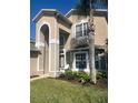 Inviting two-story home with stucco finish, manicured lawn, and well-kept landscaping at 2719 Lakemoor Dr, Orlando, FL 32828