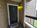 Cozy condo front door featuring a welcome mat and a charming unit number plaque at 4401 Thornbriar Ln # 202, Orlando, FL 32822