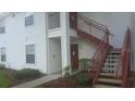 White two-story apartment building with red stairways leading to the second floor entryways at 11544 Westwood Blvd # 1325, Orlando, FL 32821