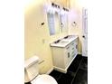 Double vanity bathroom with a quartz countertop and modern lighting at 912 W 5Th St, Lakeland, FL 33805