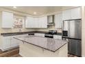 Modern kitchen with stainless steel appliances and granite countertops at 912 W 5Th St, Lakeland, FL 33805