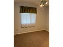 Neutral bedroom features a ceiling fan and a window with curtains at 5027 Se 109Th Pl, Belleview, FL 34420