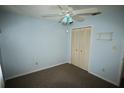 This bedroom features a ceiling fan and a closet with bifold doors at 5027 Se 109Th Pl, Belleview, FL 34420