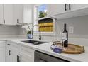 Bright kitchen counter with quartz countertops, stylish fixtures and modern appliances at 1321 Cloverlawn Ave, Orlando, FL 32806