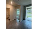 Bright and spacious entryway with tile flooring and views to the living room and bathroom at 2008 Red Rock Rd, New Smyrna Beach, FL 32168