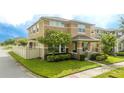 Two-story house with a tan exterior, landscaping, and a fenced yard at 16467 Olive Hill Dr, Winter Garden, FL 34787