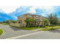 Two-story house with a tan exterior, landscaping, and a fenced yard at 16467 Olive Hill Dr, Winter Garden, FL 34787