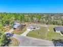 An aerial view of the single-Gathering home showing its position on the street among a tree-filled landscape at 15062 Sw 63Rd Court Rd, Ocala, FL 34473