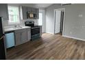 Modern kitchen with gray cabinets, stainless steel appliances, and wood flooring at 0 2Nd St, Oviedo, FL 32765