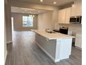 Modern kitchen featuring island, white cabinets, and stainless steel appliances at 9279 Gran Teatro Dr, Winter Garden, FL 34787