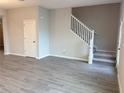 Living room with gray tile floors and staircase at 9279 Gran Teatro Dr, Winter Garden, FL 34787