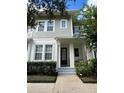 Two-story townhome featuring a charming front porch and neatly landscaped yard at 1366 Ponce Dr, Celebration, FL 34747