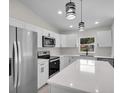 Modern kitchen with stainless steel appliances and white shaker cabinets at Tbd Kilgore St, Wildwood, FL 34785