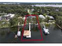 Stunning aerial view of waterfront property with boat docks and lush greenery at 904 Main St, Windermere, FL 34786