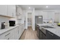 Modern kitchen boasts stainless steel appliances, granite countertops, and ample cabinet space at 487 Toscano St, Clermont, FL 34715
