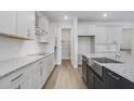 Modern kitchen boasts stainless steel appliances, granite countertops, and ample cabinet space at 487 Toscano St, Clermont, FL 34715