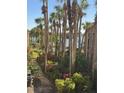 Grounds of condo complex including towering palm trees, mature plants, flowers and path to lake at 588 Orange Dr # 131, Altamonte Springs, FL 32701