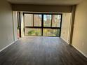 Spacious room with sliding glass door leading to beautiful view of lush landscaping and waterfront at 588 Orange Dr # 131, Altamonte Springs, FL 32701