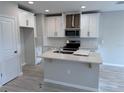 Spacious kitchen featuring modern white cabinets and an island at 5072 Rain Shadow Dr, Saint Cloud, FL 34772