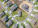 Aerial view of property lines in a neighborhood showcasing manicured lawns, paved streets, and a community setting at 16033 Barkly Ridge Ct, Winter Garden, FL 34787