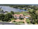 Expansive lakefront property showcasing a luxurious home with a private dock and sprawling grounds at 1965 Lake Markham Preserve Trl, Sanford, FL 32771