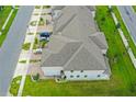 An aerial view shows the layout of the townhome including the roof, landscaping, and parking at 15259 Willow Arbor Cir, Orlando, FL 32824