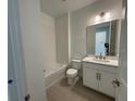 Well-lit bathroom with tub/shower combination, and large vanity with modern fixtures at 2560 Cavanaugh Dr, Orlando, FL 32817